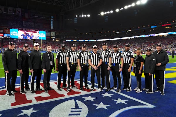 Officials including side judge Eugene Hall; side judge Allen Baynes; back judge Tony Josselyn; referee John Hussey; down judge Dana McKenzie; back judge Matt Edwards and umpire Terry Killens pose before an NFL wild card playoff football game between the Los Angeles Rams and Minnesota Vikings, Monday, Jan. 13, 2025, in Glendale, Ariz. (AP Photo/Ross D. Franklin)