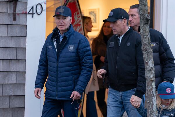 President Joe Biden and son Hunter Biden walk in downtown Nantucket Mass., Friday, Nov. 29, 2024. (AP Photo/Jose Luis Magana)