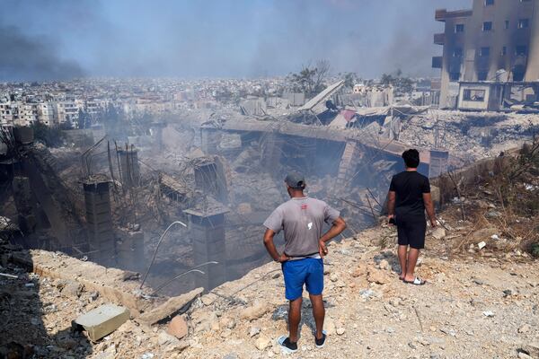 FILE - People check a building damaged by an Israeli airstrike in Choueifat, Lebanon, Sept. 28, 2024. (AP Photo/Hussein Malla, File)