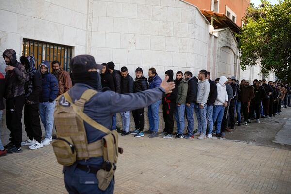 Members from Bashar Assad's Syrian army period line up to register with Syrian rebels as part of a "identification and reconciliation process" at a army compound in Latakia, Syria, Tuesday Dec. 17, 2024.(AP Photo/Leo Correa)