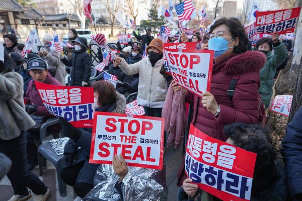 Supporters of impeached South Korean President Yoon Suk Yeol hold signs reading "Release the president" during a rally to oppose his impeachment near the Constitutional Court in Seoul, South Korea, Wednesday, Jan. 22, 2025. (AP Photo/Lee Jin-man)