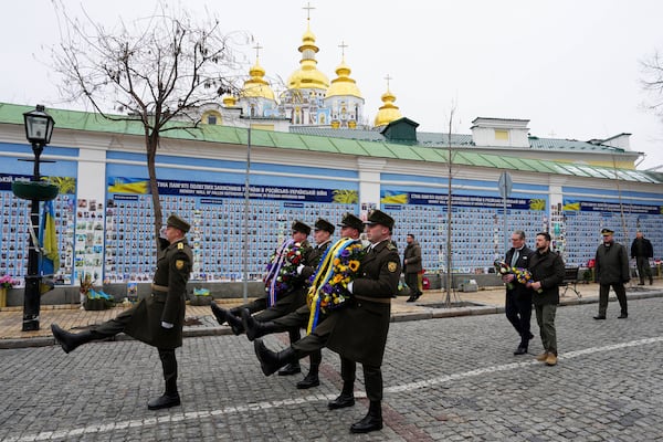 British Prime Minister Keir Starmer and Ukrainian President Volodymyr Zelenskyy arrive to lay wreaths at The Wall of Remembrance of the Fallen for Ukraine, in Kyiv, Ukraine Thursday, Jan. 16, 2025. (Carl Court/Pool Photo via AP)