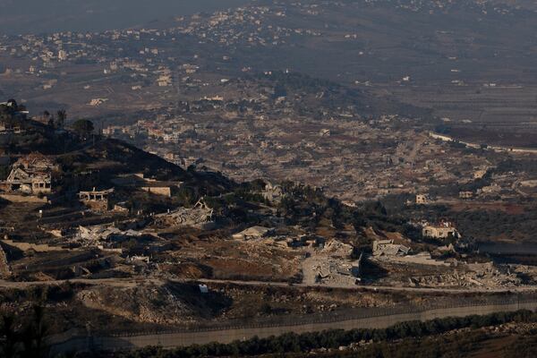 Destroyed buildings in the village of Kfar Kila, southern Lebanon, are seen from northern Israel, Tuesday, Dec. 3, 2024. (AP Photo/Maya Alleruzzo)