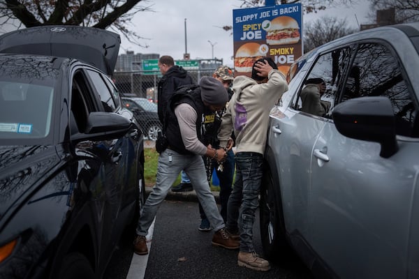 FILE - A deportation officer changes the handcuffs of Wilmer Patricio Medina-Medina from back to front after arresting him during an early morning operation, Dec. 17, 2024, in the Bronx borough of New York. (AP Photo/Julia Demaree Nikhinson, File)