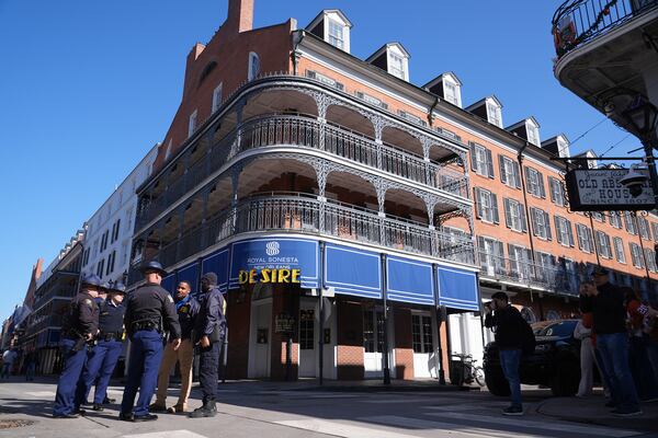 Law enforcement gather in front of the Sonesta Hotel on Bourbon Street, Thursday, Jan. 2, 2025 in New Orleans. (AP Photo/George Walker IV)