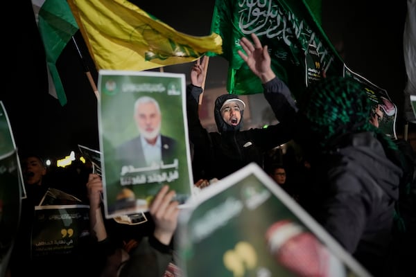 Palestinians react as they wait for the arrival of the released Palestinian prisoners, in the West Bank city of Beitunia, on Sunday, Jan. 19, 2025. (AP Photo/Leo Correa)