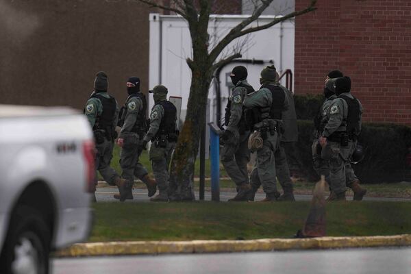 Police officers walk outside of Indiana State Prison where, barring last-minute court action or intervention by Gov. Eric Holcomb, Joseph Corcoran, 49, convicted in the 1997 killings of his brother and three other people, is scheduled to be put to death by lethal injection before sunrise Tuesday, Dec. 17, 2024, in Michigan City, Ind. (AP Photo/Erin Hooley)