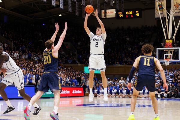 Duke's Cooper Flagg (2) attempts a shot over Notre Dame's J.R. Konieczny (20) during the second half of an NCAA college basketball game in Durham, N.C., Saturday, Jan. 11, 2025. (AP Photo/Ben McKeown)