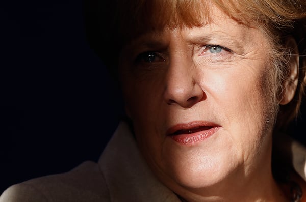 File - German Chancellor Angela Merkel is pictured with light and shadow at the Meseberg palace near Berlin, Germany, Thursday, Jan. 23, 2014. (AP Photo/Michael Sohn, File)