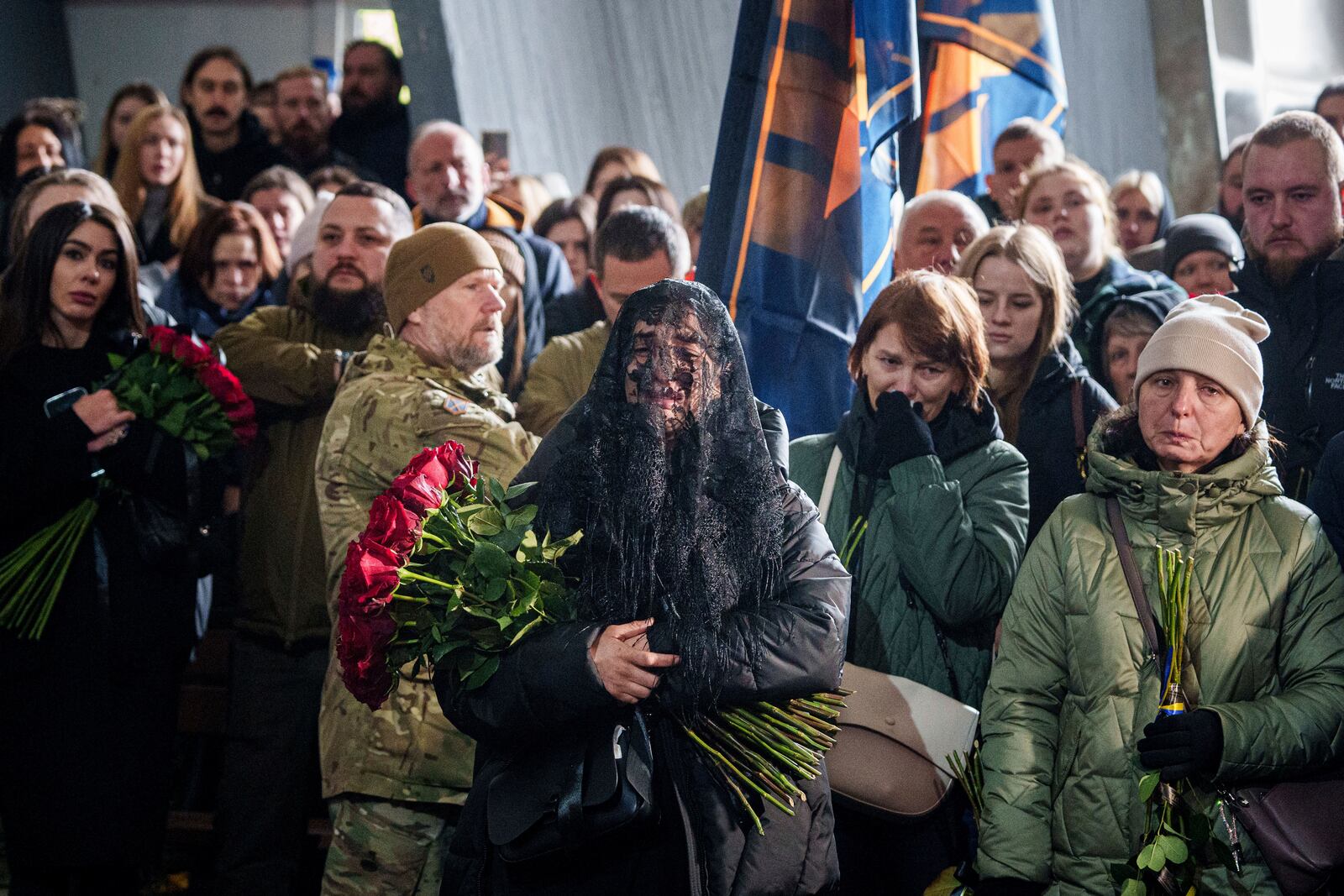 A woman cries near the coffin of Valentyna Nagorna aka "Valkiria", Ukrainian military medic of 3rd assault brigade, who was killed together with his boyfriend Danylo Liashkevych aka "Berserk, during the funeral ceremony at crematorium in Kyiv, Ukraine, Friday, Nov. 8, 2024. (AP Photo/Evgeniy Maloletka)