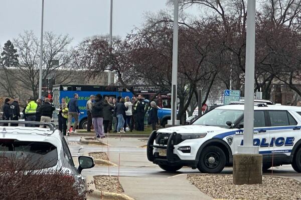 Emergency vehicles are parked outside of the SSM Health clinic where parents are being reunified with children after a shooting at the Abundant Life Christian School in Madison, Wis., Monday, Dec. 16, 2024. (AP Photo/Scott Bauer)