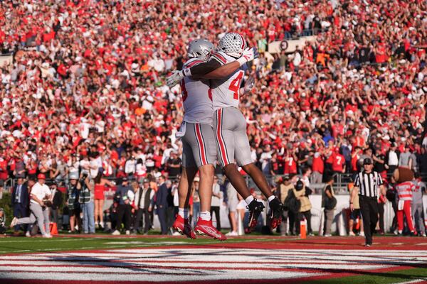 Ohio State tight end Will Kacmarek, left, and wide receiver Jeremiah Smith (4) celebrate Smith's touchdown against Oregon during the first half in the quarterfinals of the Rose Bowl College Football Playoff, Wednesday, Jan. 1, 2025, in Pasadena, Calif. (AP Photo/Mark J. Terrill)