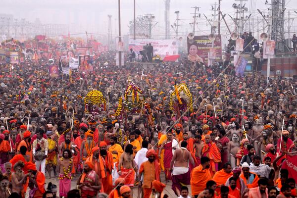 Naga Sadhus of Juna Akhara arrive for ritualistic dip at Sangam, the confluence of the Rivers Ganges, Yamuna and mythical Saraswati on one of the most auspicious day Makar Sankranti, for the Maha Kumbh festival in Prayagraj, India, Tuesday, Jan. 14, 2025. (AP Photo/Rajesh Kumar Singh)