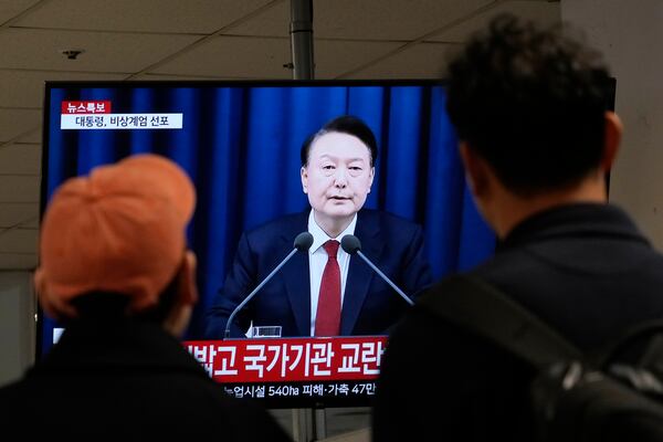 People watch a TV screen showing South Korean President Yoon Suk Yeol's televised briefing at a bus terminal in Seoul, South Korea, Tuesday, Dec. 3, 2024. (AP Photo/Ahn Young-joon)