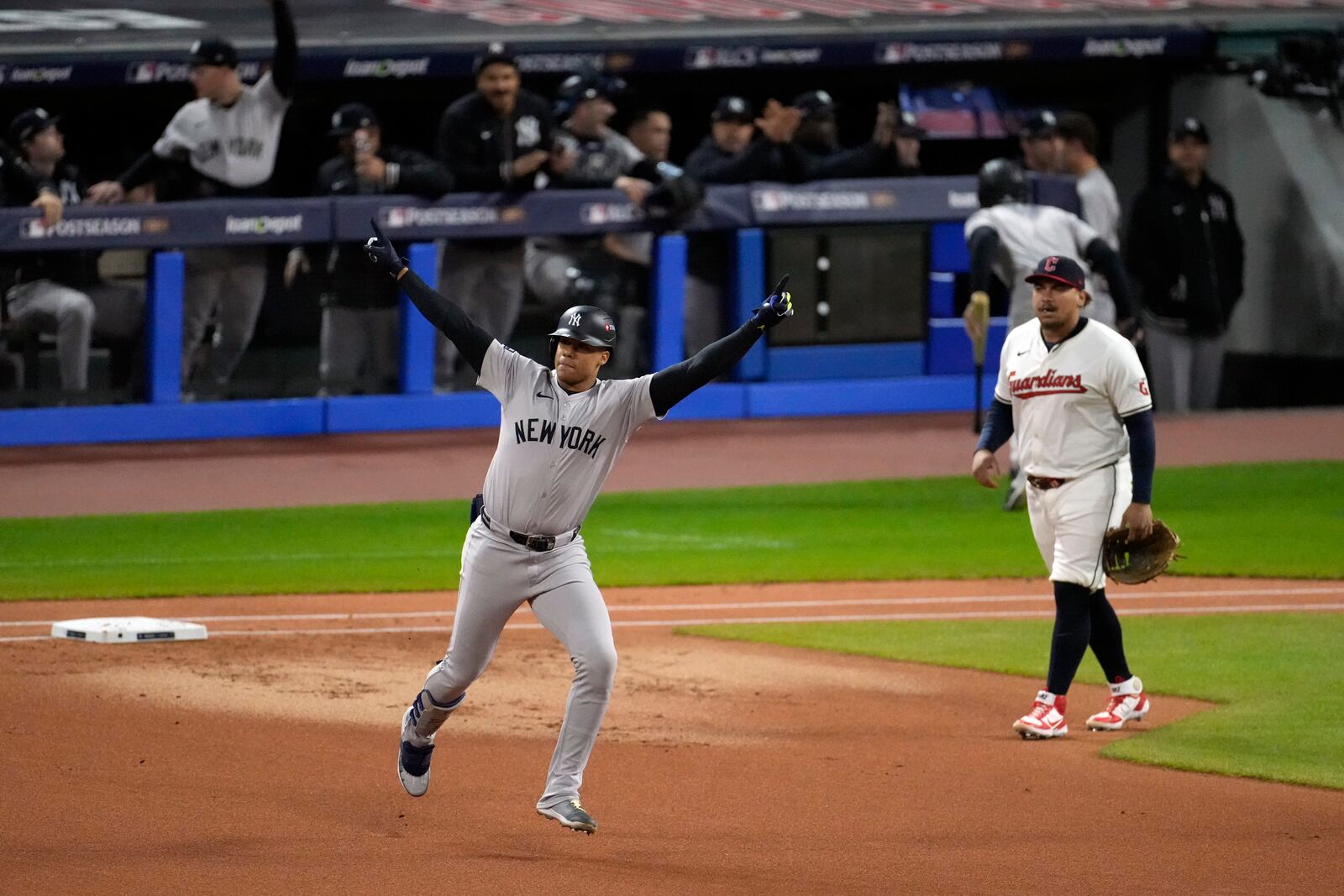 New York Yankees' Juan Soto, left, celebrates after hitting a two-run home run against the Cleveland Guardians during the first inning in Game 4 of the baseball AL Championship Series Friday, Oct. 18, 2024, in Cleveland. (AP Photo/Jeff Roberson)