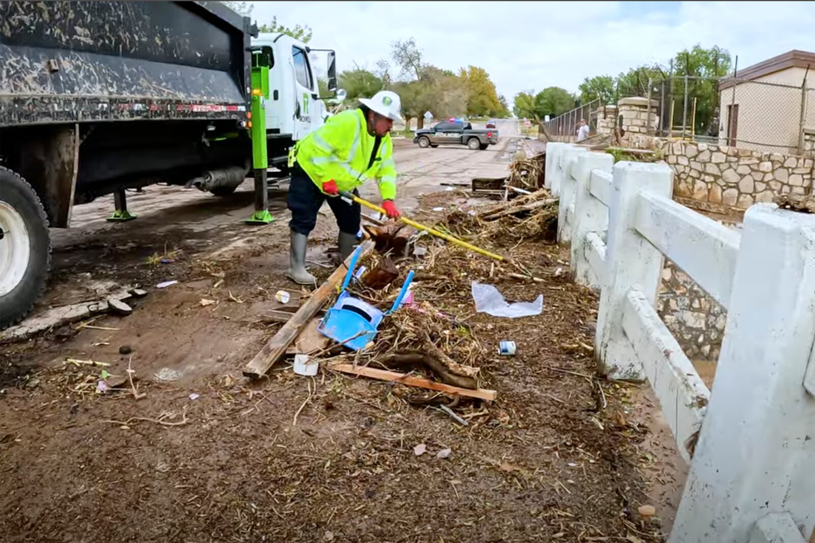 In this image taken from video, a man removes debris from severe flooding in Roswell, N.M., Sunday, Oct. 20, 2024. (Juliana Halvorson via AP)