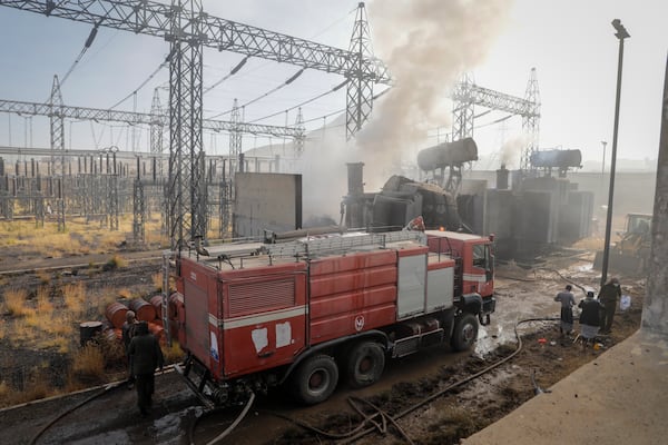 Firefighters work at the scene of an Israeli airstrike on the Haziz power station in southern Sanaa, Yemen, Thursday, Dec. 19, 2024. A series of intense Israeli airstrikes rocked Yemen's rebel-held capital and a port city early Thursday, killing at least nine people, according to officials. This attack came shortly after a Houthi missile targeted central Israel. (AP Photo/Osamah Abdulrahman)