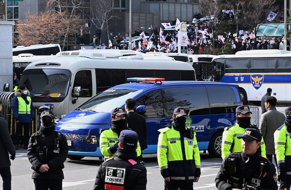 A vehicle carrying impeached South Korean President Yoon Suk Yeol arrives at the Seoul Western District Court in Seoul, South Korea, Saturday, Jan. 18, 2025. (Kim Min-Hee/Pool Photo via AP)