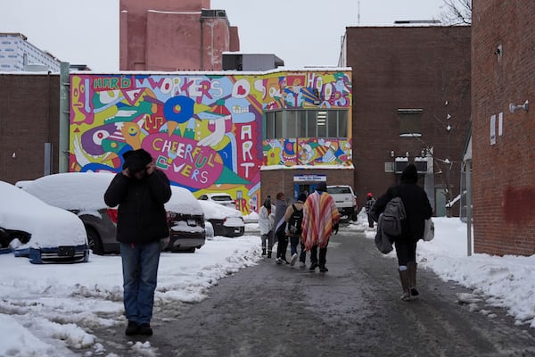 People walk toward a daytime warming shelter, Tuesday, Jan. 7, 2025, in Cincinnati. (AP Photo/Joshua A. Bickel)