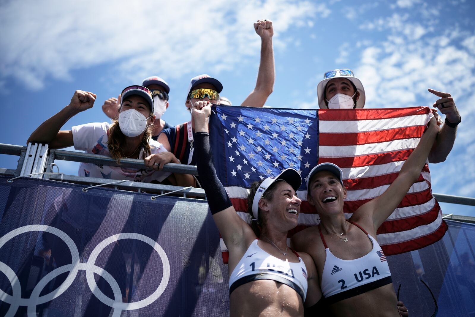 FILE - April Ross, bottom left, of the United States, and teammate Alix Klineman, bottom right, celebrate after winning a women's beach volleyball gold medal match against Australia at the 2020 Summer Olympics, Aug. 6, 2021, in Tokyo, Japan. (AP Photo/Felipe Dana, File)