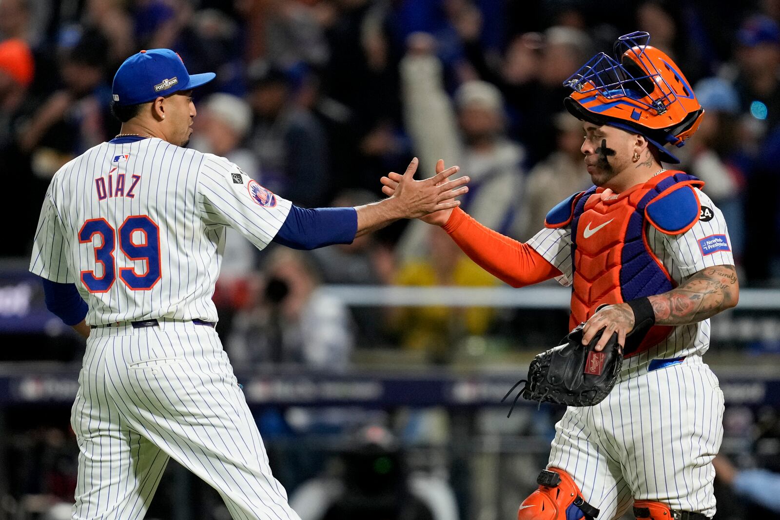 New York Mets pitcher Edwin Díaz and catcher Francisco Alvarez celebrates their win against the Los Angeles Dodgers in Game 5 of a baseball NL Championship Series, Friday, Oct. 18, 2024, in New York. (AP Photo/Ashley Landis)