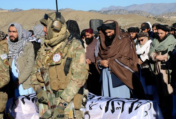 Acting interior minister Sirajuddin Haqqani, center, and mourners offer funeral prayers near the dead body of Khalil Haqqani, the minister for refugees and repatriation, during his funeral procession in eastern Paktia province, Afghanistan, Thursday, Dec. 12, 2024.(AP Photo/Saifullah Zahir)