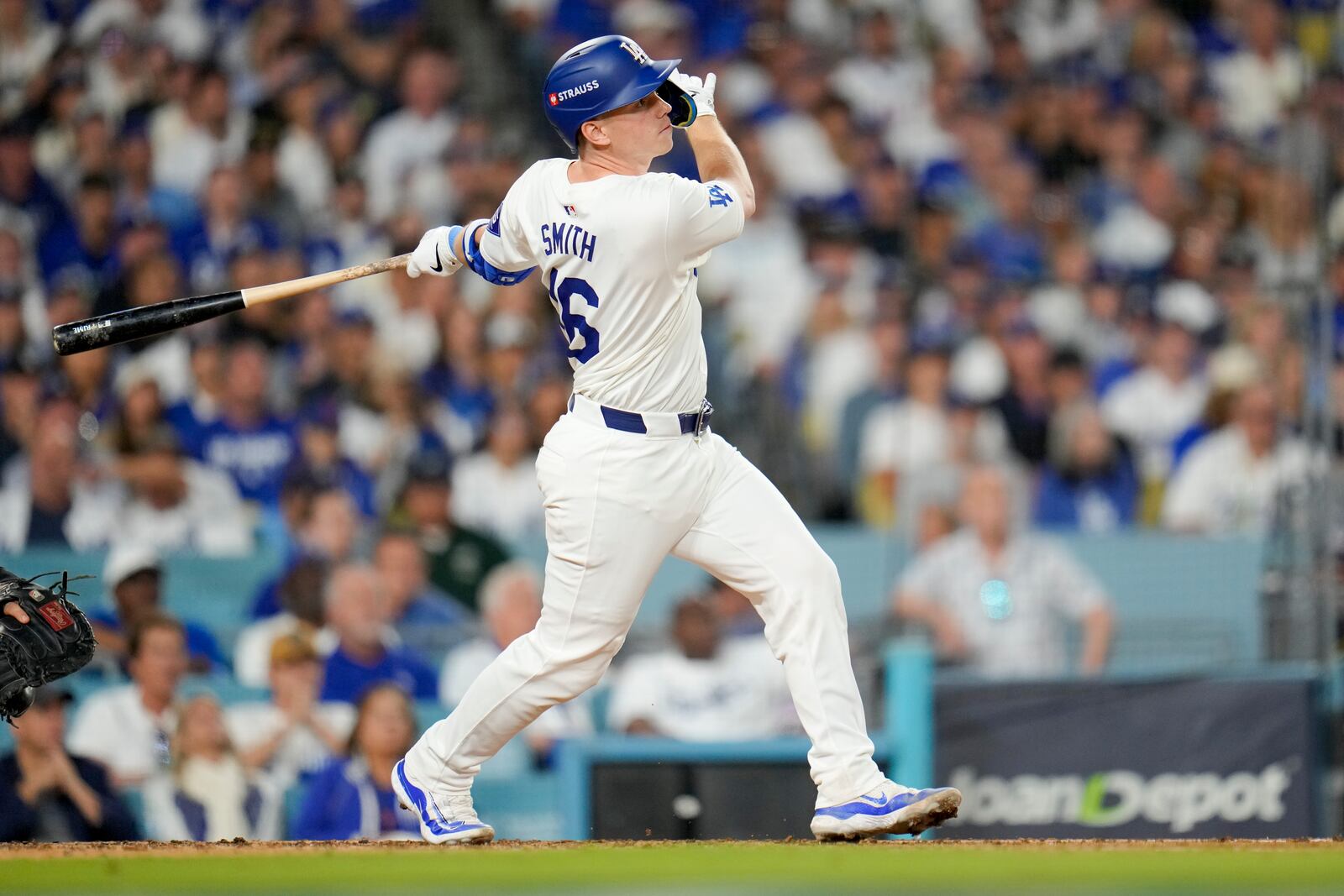 Los Angeles Dodgers' Will Smith watches his two-run home run against the New York Mets during the third inning in Game 6 of a baseball NL Championship Series, Sunday, Oct. 20, 2024, in Los Angeles. (AP Photo/Julio Cortez)