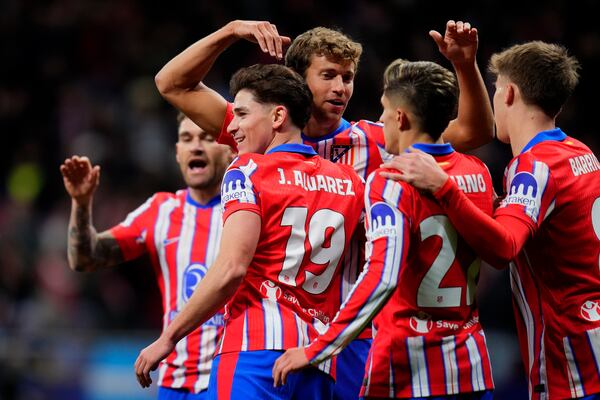 Atletico Madrid's Julian Alvarez (19) celebrates with teammates after scoring the opening goal during the Champions League opening phase soccer match between Atletico Madrid and Slovan Bratislava at Riyadh Air Metropolitano stadium in Madrid, Spain, Wednesday, Dec. 11, 2024. (AP Photo/Manu Fernandez)