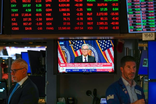 Screens display a news conference by Federal Reserve Chair Jerome Powell on the floor of the New York Stock Exchange in New York, Wednesday, Jan. 29, 2025. (AP Photo/Seth Wenig)