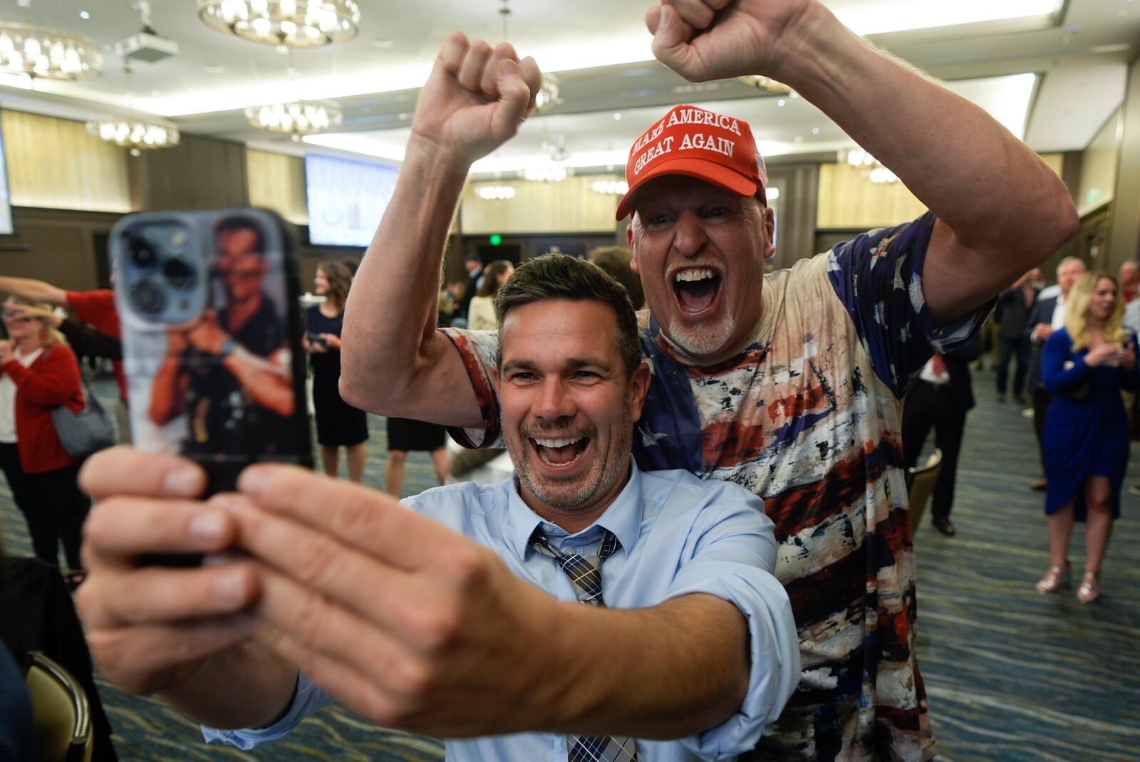 Supporters celebrate and take selfies during an election watch party for Republican U.S. Senate candidate Eric Hovde, Wednesday, Nov. 6, 2024, in Madison, Wis. (AP Photo/Morry Gash)