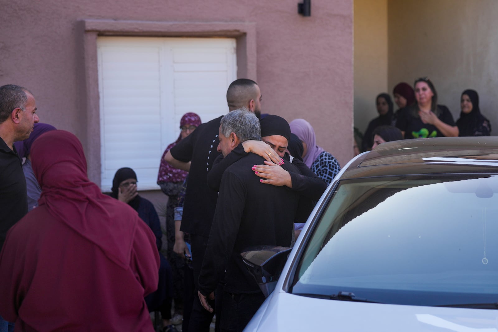 People react at the site where one person was killed after a projectile launched from Lebanon slammed into Maalot-Tarshiha, northern Israel, Tuesday, Oct. 29, 2024. (AP Photo/Ohad Zwigenberg)