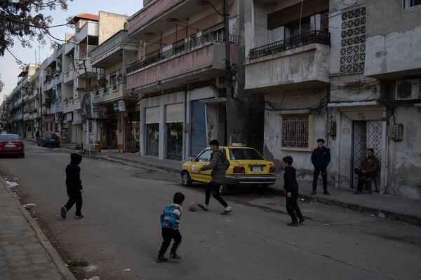 Boys play soccer on a street in an Alawite neighbourhood, in Homs, Syria, Thursday, Dec. 26, 2024. (AP Photo/Leo Correa)