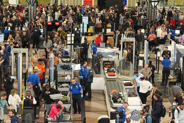 Travelers wade through the south security checkpoint in Denver International Airport Thursday, Dec. 19, 2024, in Denver. (AP Photo/David Zalubowski)