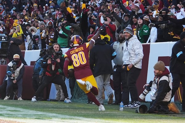 Washington Commanders wide receiver Jamison Crowder (80) scores a touchdown against the Philadelphia Eagles during the first half of an NFL football game, Sunday, Dec. 22, 2024, in Landover, Md. (AP Photo/Stephanie Scarbrough)