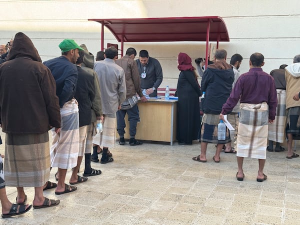 This photo released by the International Committee of the Red Cross shows its officials helping prisoners prepare to be freed by Yemen's Houthi rebels, in Sanaa, Yemen, Saturday, Jan. 25, 2025. (International Committee of the Red Cross via AP)