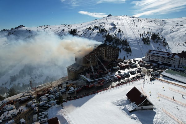 Firefighters work to extinguish a fire in a hotel at a ski resort of Kartalkaya, located in Bolu province, in northwest Turkey, Tuesday, Jan. 21, 2025. (Enes Ozkan/IHA via AP)