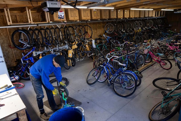 Volunteer Gerry Friberg scraps a bike for parts in the donation annex of the Lincoln Bike Kitchen on Tuesday, Nov. 12, 2024, in Lincoln, Neb. (AP Photo/Rebecca S. Gratz)