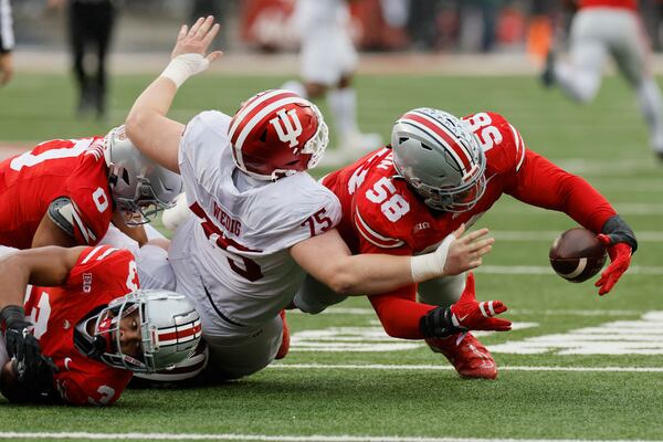 Ohio State defensive lineman Ty Hamilton, right, recovers a fumble against Indiana during the first half of an NCAA college football game Saturday, Nov. 23, 2024, in Columbus, Ohio. (AP Photo/Jay LaPrete)