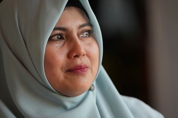 Tears well up in the eyes of Tria Asnani, a 38-year-old high school teacher teacher who is also a tsunami survivor, as he speaks with The Associated Press during an interview in Banda Aceh, Indonesia, Thursday, Dec. 12, 2024. (AP Photo/Achmad Ibrahim)