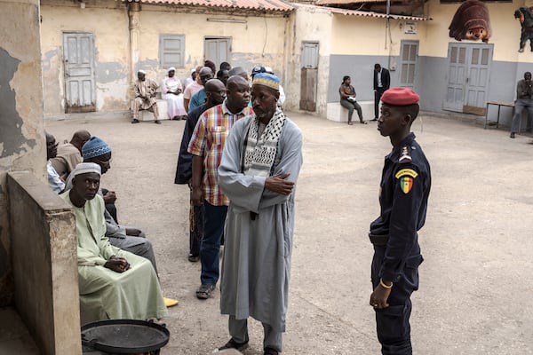 People wait to cast their ballot for legislative elections in Dakar, Senegal Sunday, Nov. 17, 2024. (AP Photo/Annika Hammerschlag)