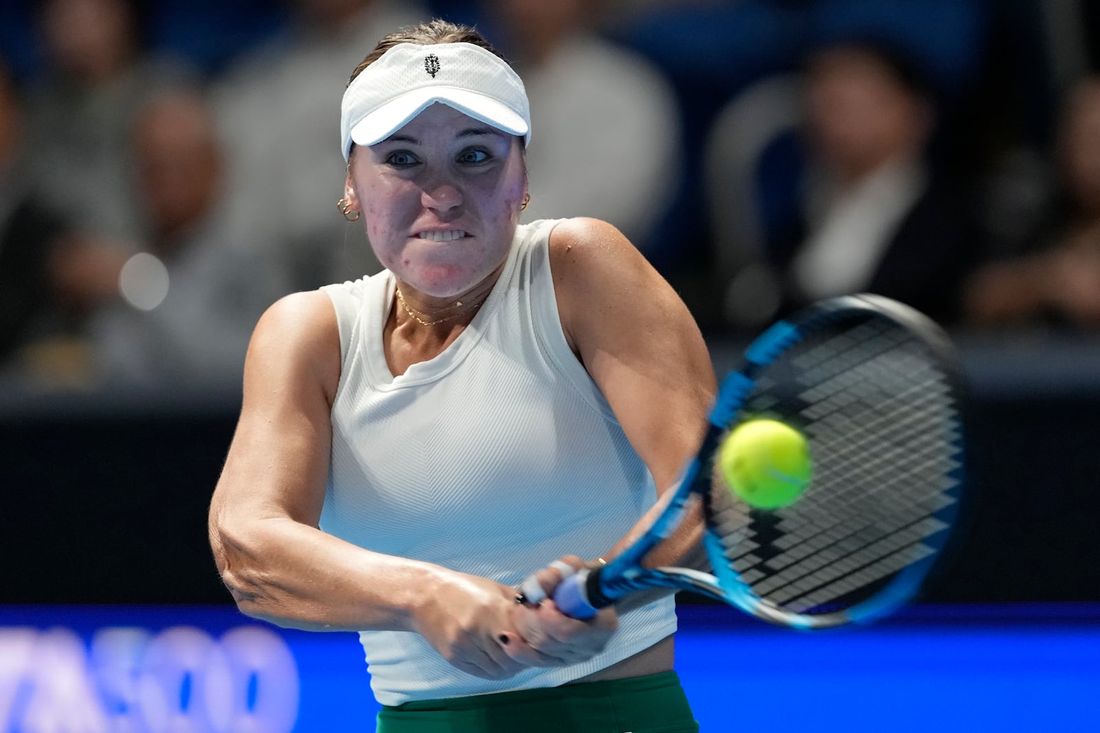 Sofia Kenin of the United States returns a shot against China's Zheng Qinwen during the final match of the Pan Pacific Open women's tennis tournament at Ariake Coliseum, in Tokyo, Sunday, Oct. 27, 2024. (AP Photo/Eugene Hoshiko)