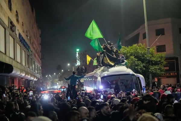 A bus carrying released Palestinian prisoners arrives to the West Bank city of Beitunia, early Monday Jan. 20, 2025. (AP Photo/Leo Correa)