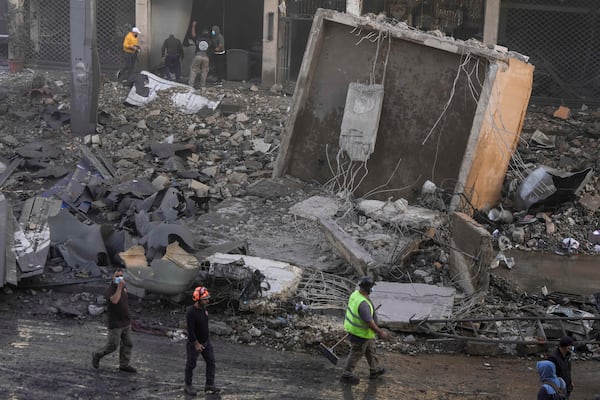 Rescuers check a building hit by an Israeli airstrike in Chiyah, the southern suburb of Beirut, Lebanon, Friday, Nov. 22, 2024. (AP Photo/Bilal Hussein)