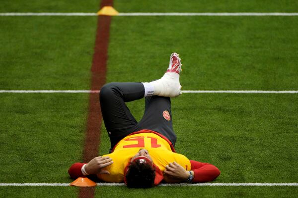 Kansas City Chiefs quarterback Patrick Mahomes stretches during the NFL football team's practice Wednesday, Jan. 22, 2025, in Kansas City, Mo. (AP Photo/Charlie Riedel)