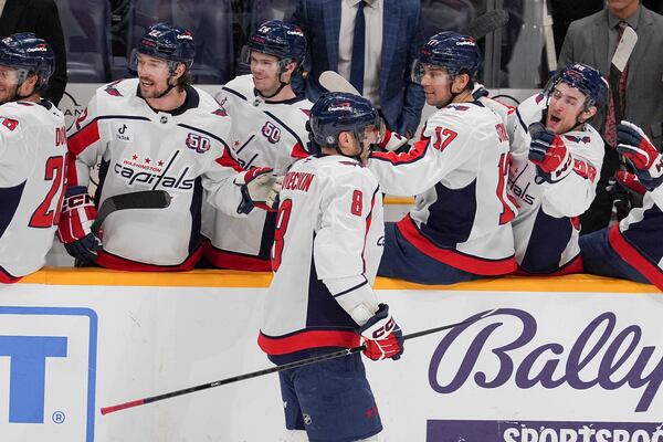 Washington Capitals left wing Alex Ovechkin (8) celebrates his empty net goal with teammates during the third period of an NHL hockey game against the Nashville Predators, Saturday, Jan. 11, 2025, in Nashville, Tenn. The Capitals won 4-1. (AP Photo/George Walker IV)