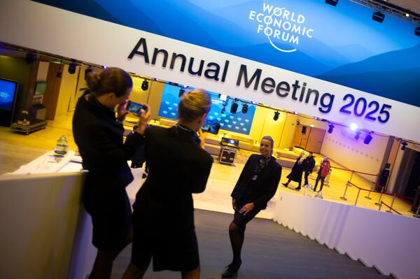 People take photos inside the Congress Center where the annual meeting of World Economic Forum will take place, in Davos, Switzerland, Sunday, Jan. 19, 2025. (AP Photo/Markus Schreiber)