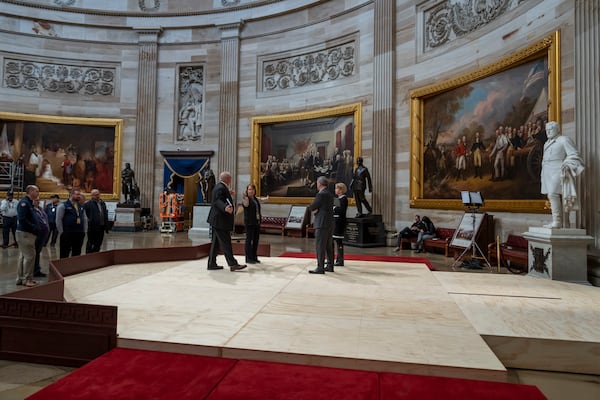 Officials inspect the construction of a stand in the Rotunda, where President-elect Donald Trump is due to take the oath of office on Monday, at the Capitol in Washington, Friday, Jan. 17, 2025. (AP Photo/Ben Curtis)