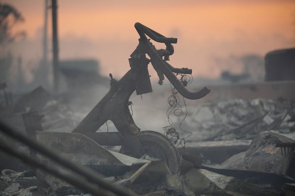 Debris covers the ground after the Palisades Fire ravaged a neighborhood amid high winds in the Pacific Palisades neighborhood of Los Angeles, Thursday, Jan. 9, 2025. (AP Photo/Damian Dovarganes)