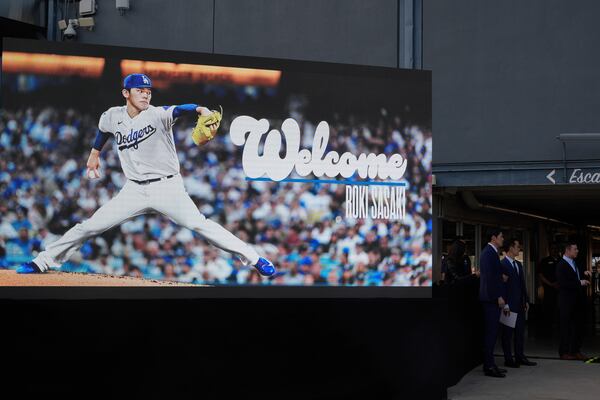 A digital display of Japanese right-hander pitcher Roki Sasaki, 23, is seen as he is introduced by the Los Angeles Dodgers at a news conference on Wednesday, Jan. 22, 2025, at Dodger Stadium in Los Angeles. (AP Photo/Damian Dovarganes)