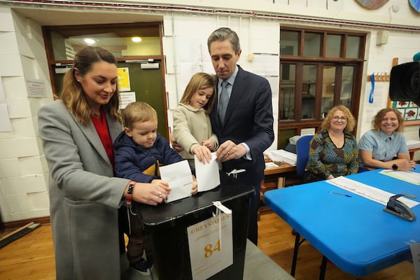 Irish Prime Minister and Fine Gael leader Simon Harris, center, accompanied by his wife Caoimhe and children Cillian and Saoirse, casts his vote at Delgany National School, County Wicklow, as voters go to the polls for the 2024 General Election in Ireland, Friday Nov. 29, 2024. (Niall Carson/PA via AP)